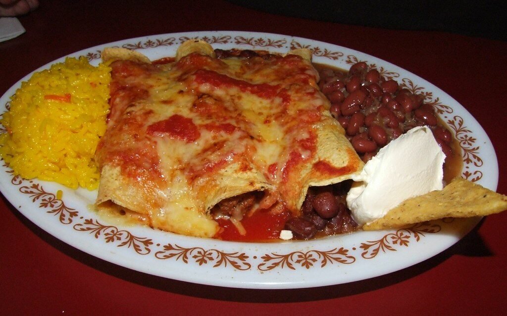 selective focus photography of burger patty, mayonnaise, and French fries served on platter