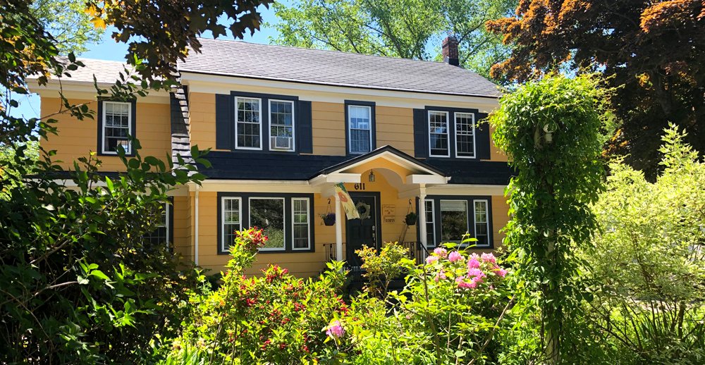 a white plate topped with a salad covered in shrimp